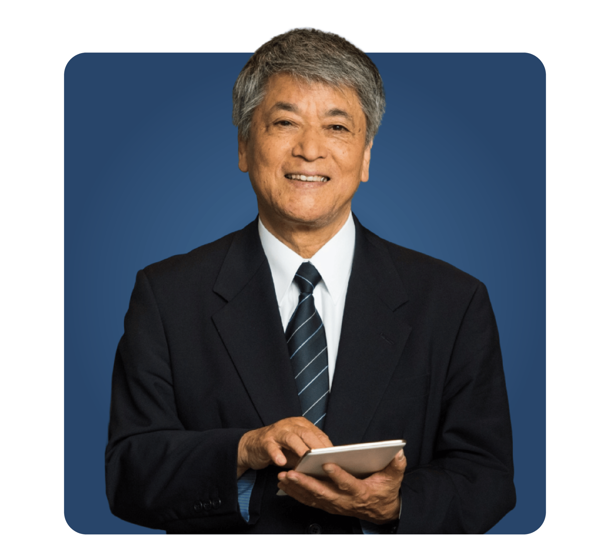 man in coat and tie with tablet in hand in front of blue square